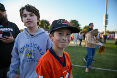 Two young boys posing for a picture at a sports event.