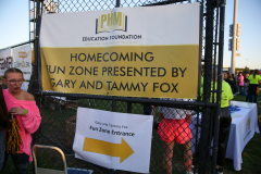 Sign at a fair advertising homecoming event in a school zone.