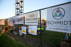 Banners on a fence at an outdoor event.