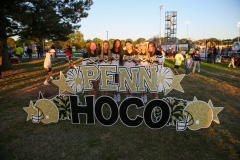 Group of people posing in front of a sign that reads "Penn HS HOCO" and "Hoco 2010".