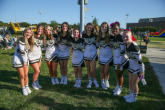 Cheerleaders posing together for a group picture at an event.
