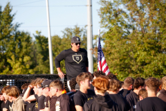 Man in black shirt standing on float during parade.