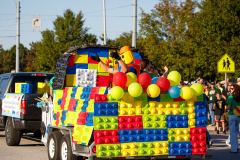 Colorful lego truck float in parade.