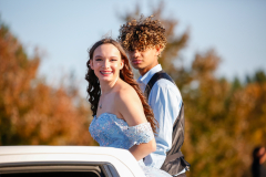 Two people in a car during a parade.