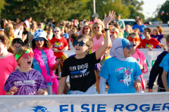 People at a parade, waving and celebrating.