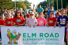 Children in front of a sign at an event.