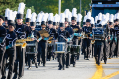 A band of musicians marching in a parade.