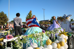 People in costumes on a float celebrating Puerto Rico during a parade.