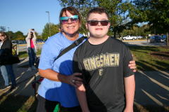 Two people posing together at a parade.