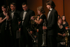 A group of musicians on stage playing instruments.
