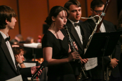 Band members on stage playing instruments".