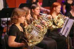 People playing musical instruments on stage.