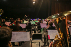 Band performing on stage in front of an audience.