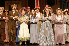 Theatrical cast of a musical performance on stage.