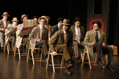 A group of men dressed in old-fashioned clothing, possibly from a production of "The Music Man".