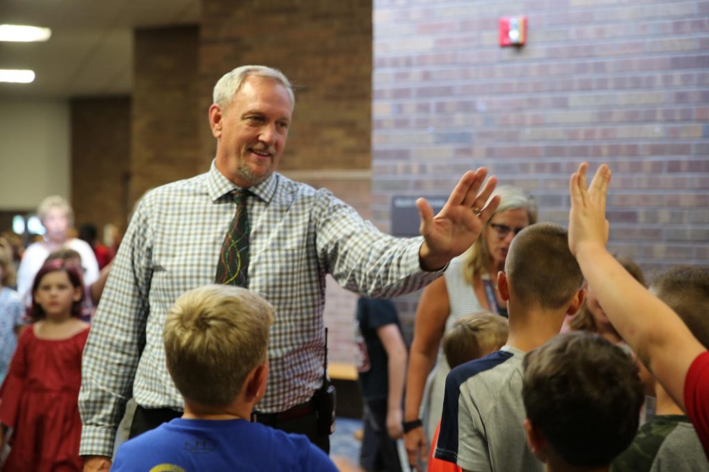 Principal Thompson high fives students
