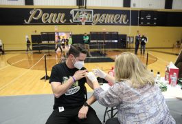 Meijer Clinical Pharmacy Specialist Amy Jennings administering vaccine to Penn Principal Sean Galiher