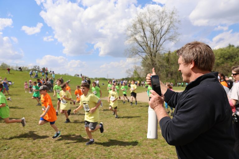 PHM parents, teachers, staff, and coaches cheer students on during the races