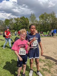 Two 4th grade boys boys pose for pictures after their race