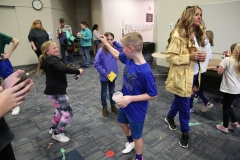 This is a photograph of children playing indoors with confetti.