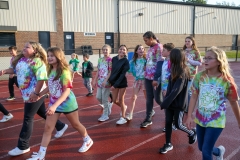 Group of people walking together in a school setting.