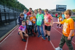 Group of people posing on a track for a walkathon event.