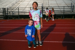 Two people at a track during a walkathon event.