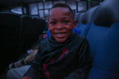 Boy smiling in airplane seat.