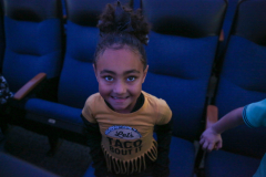 Young girl in a movie theater.