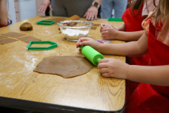 Children at a table making gingerbread cookies.