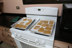 Gingerbread cookies cooling on a stove top oven.
