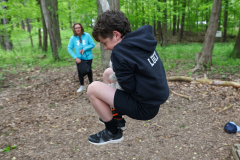 Boy jumping in the air on a trampoline at camp.