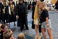 Two women posing for a picture at graduation ceremony.