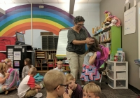 Teacher greeting students on first day of school.