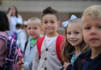 Children in school uniforms on first day of kindergarten.