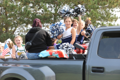 People in a truck bed celebrating an event.