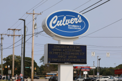 Culver's restaurant sign in front of a store.