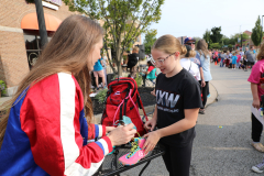 Woman signing autographs at a parade.
